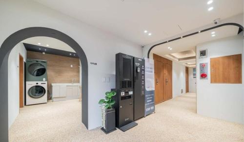 a laundry room with a washing machine and a washer and dryer at Stay Jakjeon in Incheon