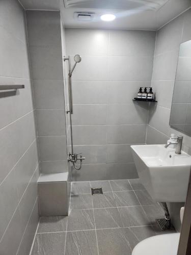 a bathroom with a shower and a sink and a toilet at Stay Jakjeon in Incheon