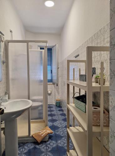 a bathroom with a white sink and a shower at Casa Celeste in Budoni