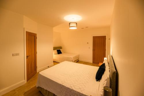 a small bedroom with two beds and a lamp at 'Amalfi' Coast Road, Oranmore in Galway