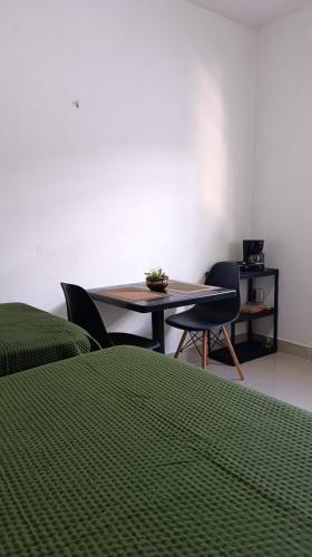a room with a table and two chairs and a table at Suite com garagem 900 metros do Mar in João Pessoa