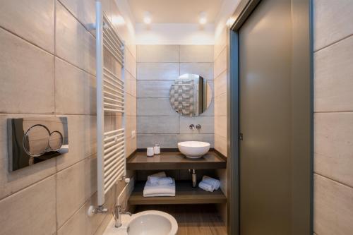 a bathroom with a sink and a mirror at Ella Stays in Santa Maria al Bagno