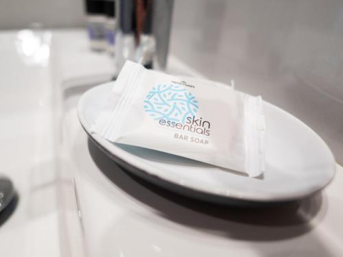 a white plate with a bag on top of it at Finikounda Hotel in Finikounta