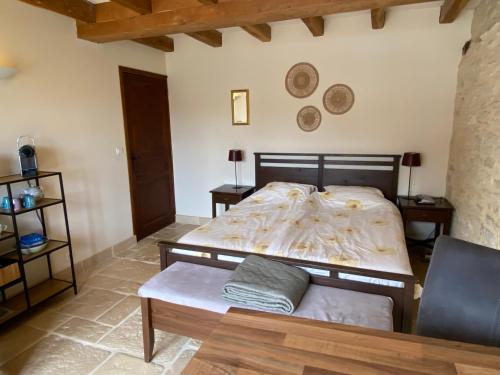 a bedroom with a bed and a couch in it at Domaine Rossignol Tournesol in Gourdon-en-quercy