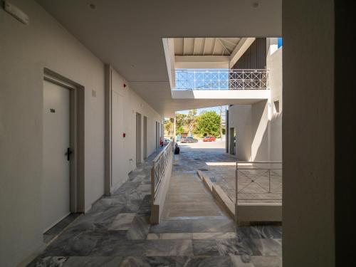 a hallway of a building with a staircase and a door at Finikounda Hotel in Finikounta