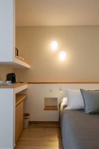 a bedroom with a bed and a kitchen with a counter at Ella Stays in Santa Maria al Bagno
