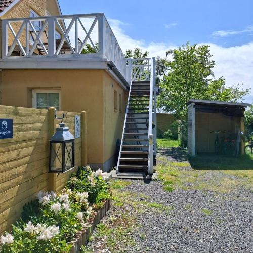 a staircase leading up to a house with flowers at Apple Blossom Studio - near Rønne and Beach in Rønne