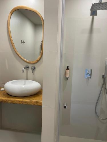 a bathroom with a sink and a mirror at Hôtel E Tre Stelle in Bonifacio