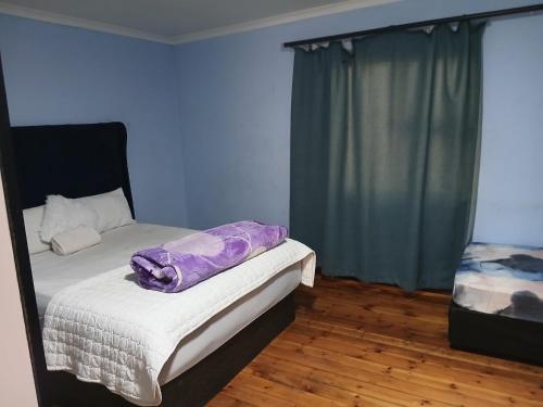 Ένα ή περισσότερα κρεβάτια σε δωμάτιο στο The Pearl Residence Guest House