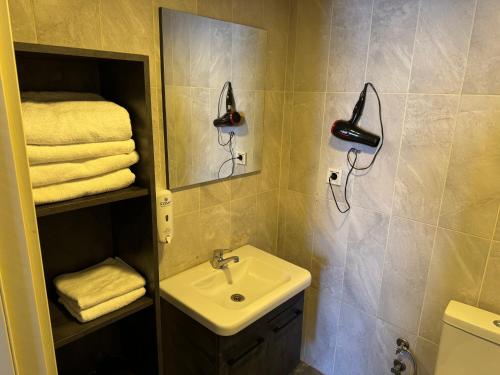 a bathroom with a sink and a mirror and towels at Pin Suite in Buyukcekmece