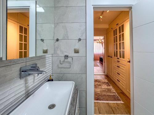 a bathroom with a white tub and a mirror at Villa Limon in Kusadası