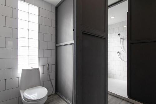 a bathroom with a white toilet and a shower at 4 Bedrooms House in Thapae/NightBazaar in Chiang Mai