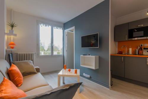 a living room with a couch and a table at Sweet Home Dijon-Arquebuse in Dijon