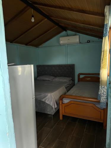 a bedroom with two beds and a ceiling at Te Taku in Fier