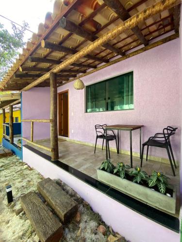 a patio with a table and chairs on a house at Pousada Cigarras da Serra in Serra do Cipo