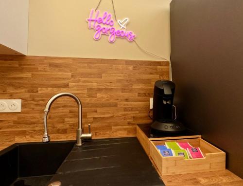 a kitchen sink with a hello surprises sign on the wall at La LUNA in Le Portel
