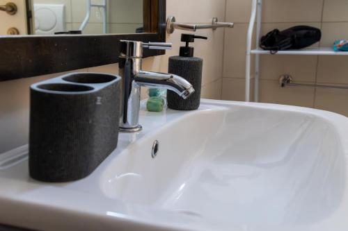 a bathroom sink with a faucet and a soap dispenser at Aparthotel Tropical Bounty Beach L02 in Santa Maria