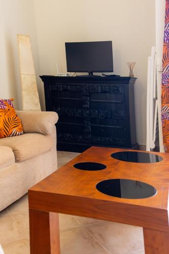 a living room with a couch and a coffee table at Aparthotel Tropical Bounty Beach L02 in Santa Maria