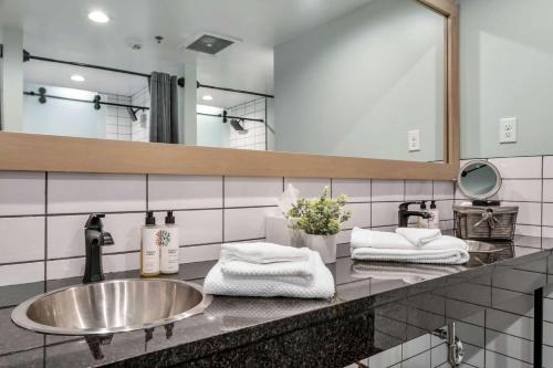a bathroom with a sink and a large mirror at Hangover Easy Suite 6BR by Maddox Hotel in Nashville
