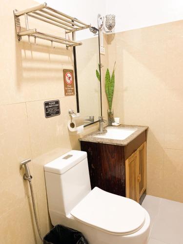 a bathroom with a toilet and a sink at PEPAYEN Homestay in General Luna