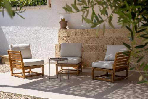 three chairs and a table on a patio at Ella Stays in Santa Maria al Bagno