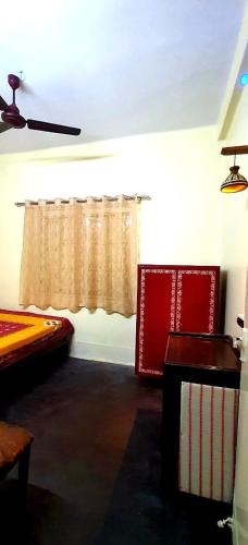 a living room with a window with a curtain at Mandira's Home in Kolkata