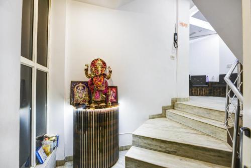 a room with stairs and a statue on the wall at The Batra Hotel Near Nizamuddin Railway Station in Jāmb