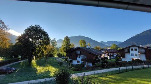 a view of a village with houses and mountains at Parkhotel Ruhpolding inklusive Chiemgaukarte in Ruhpolding