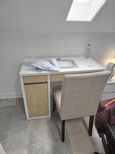 a desk with a chair in a room with a table at Balfour Street in Bradford