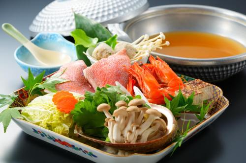a bowl of food with noodles and a bowl of soup at BeppuOnsen Hotel Sansenkaku in Beppu