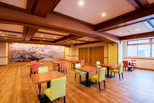 a dining room with tables and chairs at BeppuOnsen Hotel Sansenkaku in Beppu