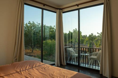 a bedroom with a bed and a large window at Casa Eva -Ocean View Rooftop, Pool - La Punta in Puerto Escondido