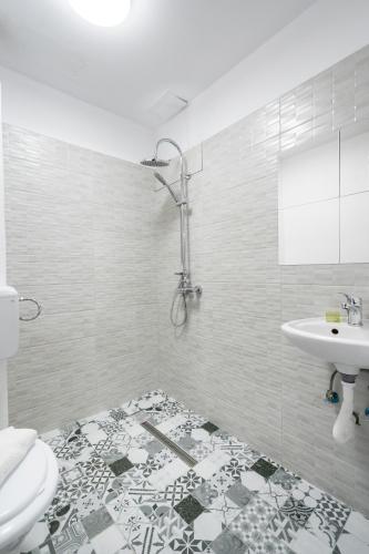 a bathroom with a sink and a toilet at Flowers Grand Hotel Bucharest in Bucharest