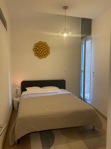 une chambre avec un lit et une horloge au mur dans l'établissement Plein coeur, à Montpellier
