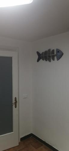 a fish decoration on a wall next to a door at Gli scogli a due passi in Portovenere