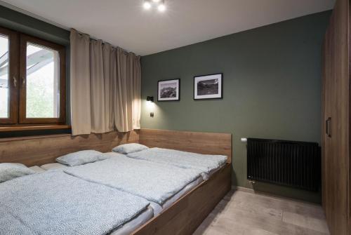 Postel nebo postele na pokoji v ubytování Liptov Trinity Apartments