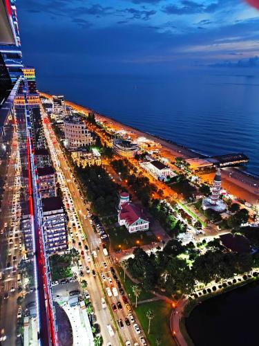 an overhead view of a city with traffic at night at Апартаменты Батуми первая линия in Batumi