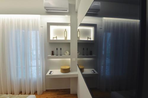 a room with white walls and a window with white curtains at Seren Studio near Victoria Metro-Earthy Tones & Comfort in Mesochórion