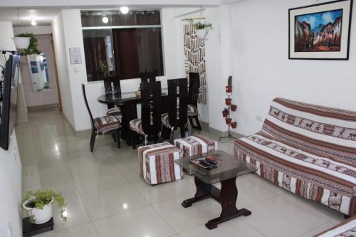 a living room with a couch and a table at Marlen's Qorywasi in Cusco