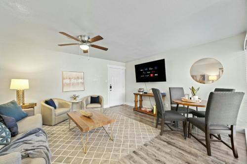 a living room with a couch and a table at Spacious and Stylish Apartment right by AT&T Stadium! in Arlington