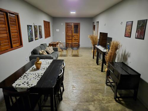 a living room with a table and a couch at Casa Seu Quinca - Portalegre, RN Brasil in Portalegre