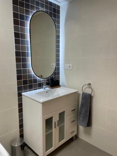 a bathroom with a white sink and a mirror at kalma in Moncófar