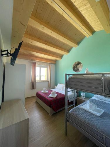 a bedroom with two bunk beds in a room at I Colori dell'Infinito in Recanati