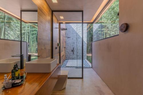a bathroom with a sink and a large window at Virá Charme Resort in Fernandes Pinheiro