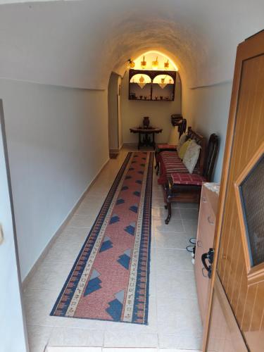 a hallway with a rug on the floor at House in the old town with view in Gjirokastër
