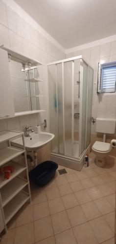 a bathroom with a shower and a sink and a toilet at Apartman Leana in Krk