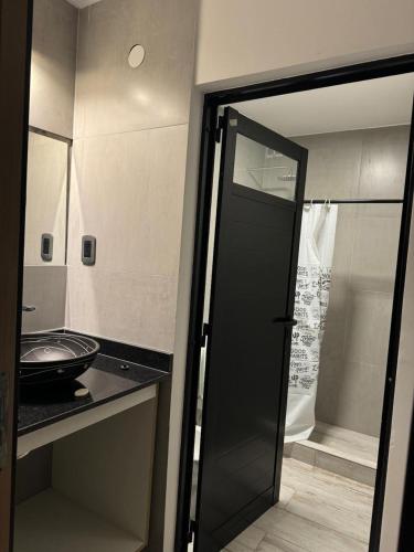 a bathroom with a glass door leading to a shower at Finca la ponderoza in Santiago del Estero