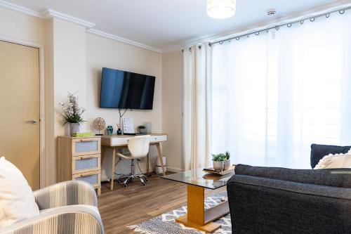 a living room with a couch and a desk at Oakdale at Centrium in Woking