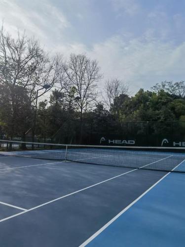 a tennis court with a tennis net on it at M Panda Tower Boutique Chengdu in Chengdu