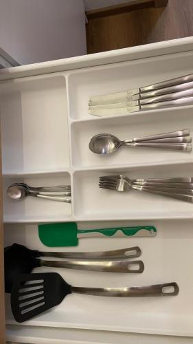 a drawer full of utensils in a cabinet at Gavner Boardinghouse Apen in Apen